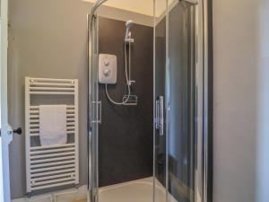a shower with a glass door in a bathroom at Gould's Farmhouse in Blandford Forum +50 photos