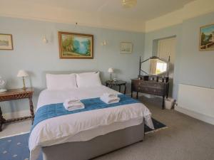 a bedroom with a bed with two towels on it at Gould's Farmhouse in Blandford Forum