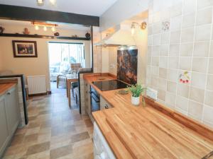 a kitchen with a sink and a counter top at Pine Cottage in Hathersage +24 photos
