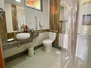 a bathroom with a toilet and a sink and a shower at CAMALEÃO Ecopousada Ltda in Linhares +28 photos