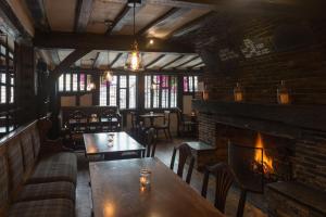 a restaurant with a fireplace and tables and chairs at Best Western The Rose & Crown Hotel in Colchester