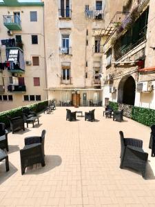 a courtyard with benches and tables and buildings at MARVIT CENTRAL LUXURY in Naples