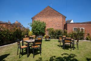 a group of tables and chairs in a yard at Best Western The Rose & Crown Hotel in Colchester