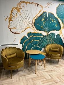 a room with two chairs and a table and a mural at Da Delfina Affittacamere in Anzio