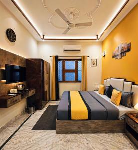 a hotel room with a bed and a tv at Hidden Leaf in Dehradun