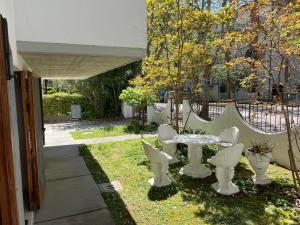 a patio with a table and chairs in a yard at Verrazzano Family in Lido di Classe