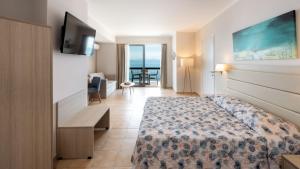 a hotel room with a bed and a television at Canvas by Mitsis Belvedere in Benitses +18 photos