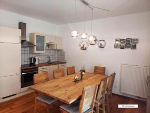 a kitchen with a wooden dining room table and chairs at Bel Appartement Bad Kleinkirchheim in Bad Kleinkirchheim