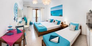 a hotel room with two beds and a table at Garden House in Hora Sfakion +62 photos