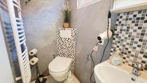a small bathroom with a toilet and a sink at Stettiner Str 6c in Grömitz