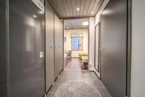 a hallway with a room with a table at Wellevi Rooms by Aavalevi in Levi +34 photos