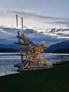 a wooden spiral staircase in the middle of a body of water at Bel Appartement Bad Kleinkirchheim in Bad Kleinkirchheim