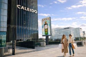 two women walking in front of a building at Winahost Madrid Towers II in Madrid +2 photos