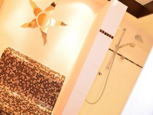 a bathroom with a shower with a mosaic shower curtain at Bauernhof König in Zwiesel