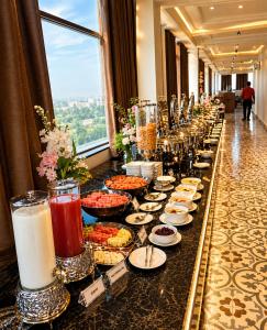 a buffet of food on a long table in a hotel at Solenne Retreat in Bodh Gaya