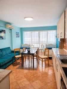 a kitchen and living room with a table and a couch at Sea view apartment 1 in Shëngjin
