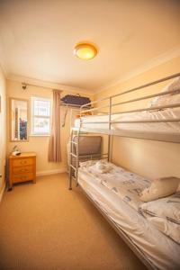 a bedroom with two bunk beds and a window at Hartland Heights in Woolacombe