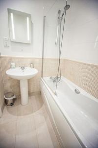 a bathroom with a sink and a bath tub and a sink at Hartland Heights in Woolacombe