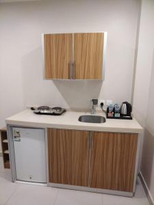 a kitchen with a sink and a counter top at SPAR Serviced Apartments- سيبار للشقق المخدومة in Al Hofuf