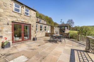 a patio with a table and chairs in front of a building at 3 Bed in Gunnerside oc-ds097 in Gunnerside