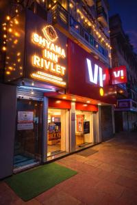 a building with a sign that says cinema inn motel at Shyama Inn by Rivlet, Delhi in New Delhi