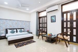 a bedroom with a bed and a table and chairs at Shyama Inn by Rivlet, Delhi in New Delhi +40 photos