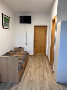 a bedroom with a bed and a television on the wall at Cazare Turnisor in Sibiu