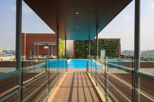 a swimming pool on the roof of a building at Renaissance Bengaluru Race Course Hotel in Bangalore