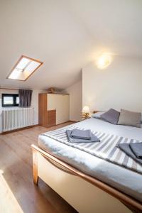 a bedroom with a large bed with a skylight at Camping Italia 90 Two Levels Apartment in Domaso +24 photos