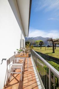 a balcony with a table and chairs on it at Camping Italia 90 Two Levels Apartment in Domaso