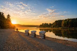 a person walking down a path next to a lake at Ferienwohnung Marina in Wiesmoor