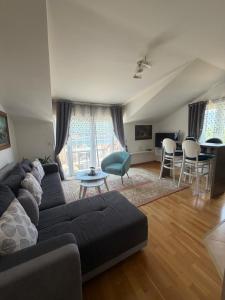 a living room with a couch and a table at Victor Kotor Sea view in Dobrota