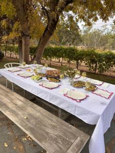 a long white table with plates of food on it at Woodlands - Vineyard setting in Penwortham