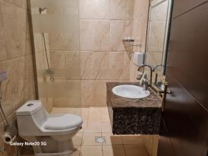 a bathroom with a toilet and a sink at Taleen Serviced Apartments Al-Ahsa- تالين الاحساء للشقق المخدومة in Ruqaiqah +22 photos