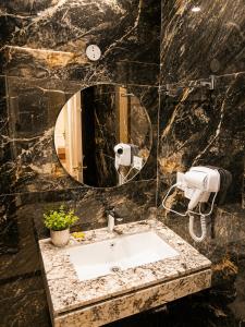 a bathroom with a sink and a mirror at Solenne Retreat in Bodh Gaya +16 photos