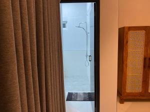 a bathroom with a shower and a glass door at The Bay House in Weligama +113 photos