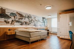 a bedroom with a bed and a mural on the wall at Braustube Wehle in Dunningen