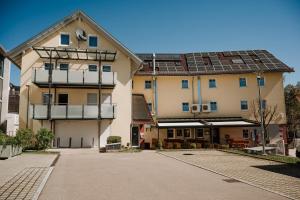 a building with solar panels on the side of it at Braustube Wehle in Dunningen