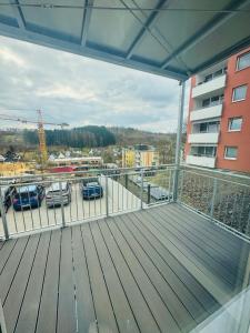 a balcony with cars parked in a parking lot at Siegen Apartments - Modern & mit Parkplatz in Siegen +2 photos