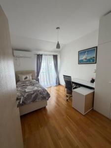a bedroom with a bed and a desk at Victor Kotor Sea view in Dobrota +17 photos
