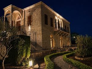 a large stone building with lights on it at night at Stone Cellars in Douma