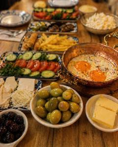 a wooden table with plates of food on it at Kasrı Hatun Konağı in Mardin