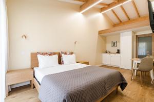a bedroom with a bed and a desk and a table at Casa Da Avó Custódia in Campo do Gerês +30 photos