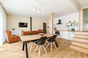 a kitchen and dining room with a wooden table and chairs at Casa Da Avó Custódia in Campo do Gerês