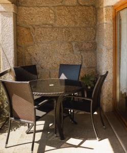 a black table and chairs on a patio at Refugio do Couto in Cabeceiras de Basto