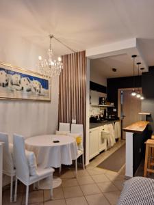 a dining room with a white table and chairs at Appartamento Merano nel cuore in Merano