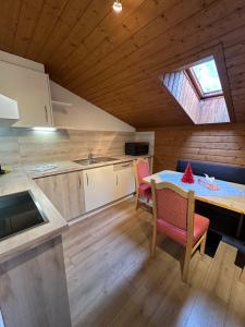 a kitchen and dining room with a table and a window at Haus Raimund in Längenfeld