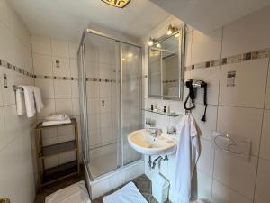 a bathroom with a sink and a shower at Gästehaus Zugspitzblick in Berwang +56 photos