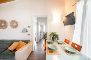 a living room with a couch and a dining table at Camping Italia 90 Apartments in Domaso