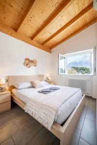 a bedroom with a large bed and a window at Camping Italia 90 Apartments in Domaso